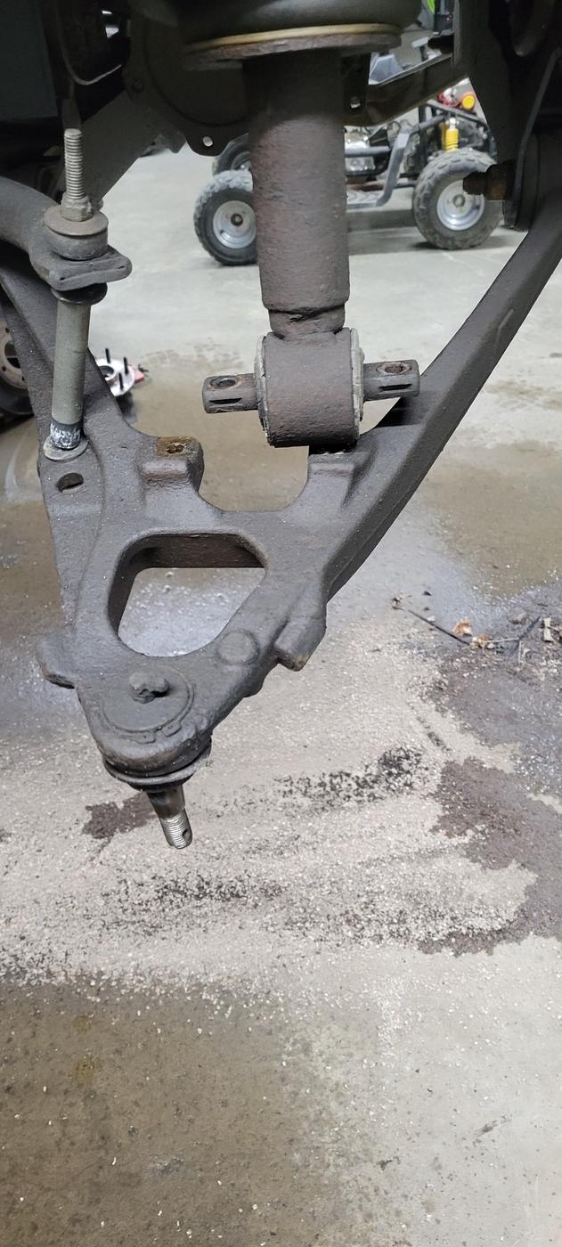 A control arm with ball joint and bushing, removed from a vehicle