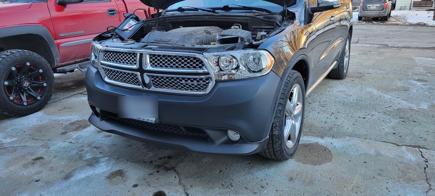 A Dodge Durango with the hood up and the engine bay exposed